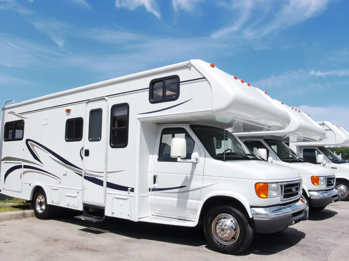 Class C motorhomes sitting on an RV lot for when you are thinking about buying an RV