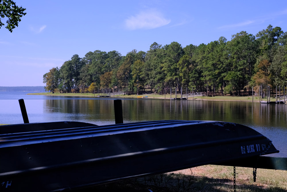 Toledo Bend Reservoir Rental boats in the foreground with one of the spots for the best fishing in Louisiana in the background, Toledo Bend Reservoir.